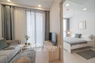 Modern apartment interior with cozy living room and stylish bedroom, featuring elegant decor and natural light.