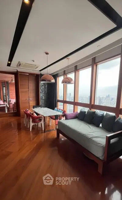 Luxurious living room with panoramic city view and elegant wooden flooring.
