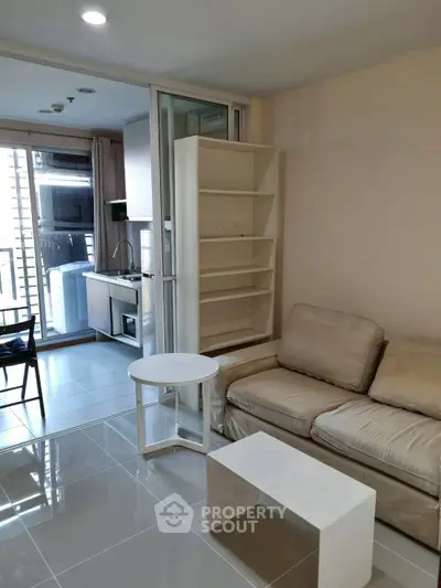 Modern living room with cozy sofa and open kitchen layout in urban apartment