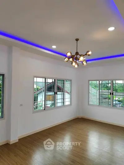 Spacious corner unit with modern lighting and large windows offering great views.