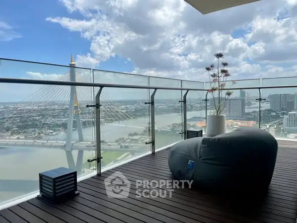 Stunning balcony with panoramic river view and modern seating, perfect for relaxation.