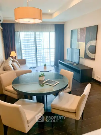 Modern living room with stylish furniture and large windows offering city views.