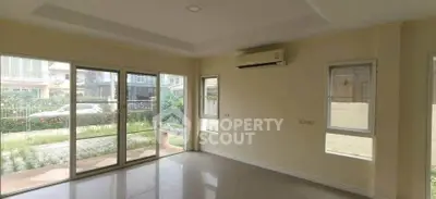 Spacious living room with large windows and garden view in modern home