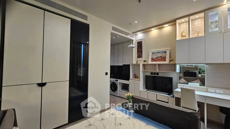 Modern studio apartment with sleek design, featuring built-in storage, cozy living area, and compact kitchen.