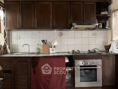 Charming kitchen with wooden cabinets and modern appliances, perfect for culinary enthusiasts.