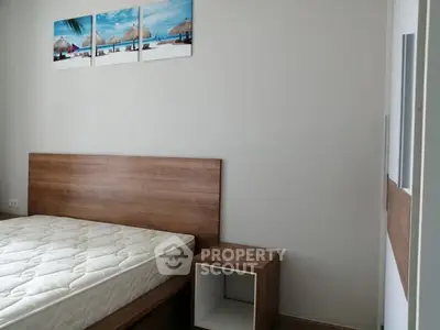 Modern bedroom with wooden furniture and beach-themed wall art