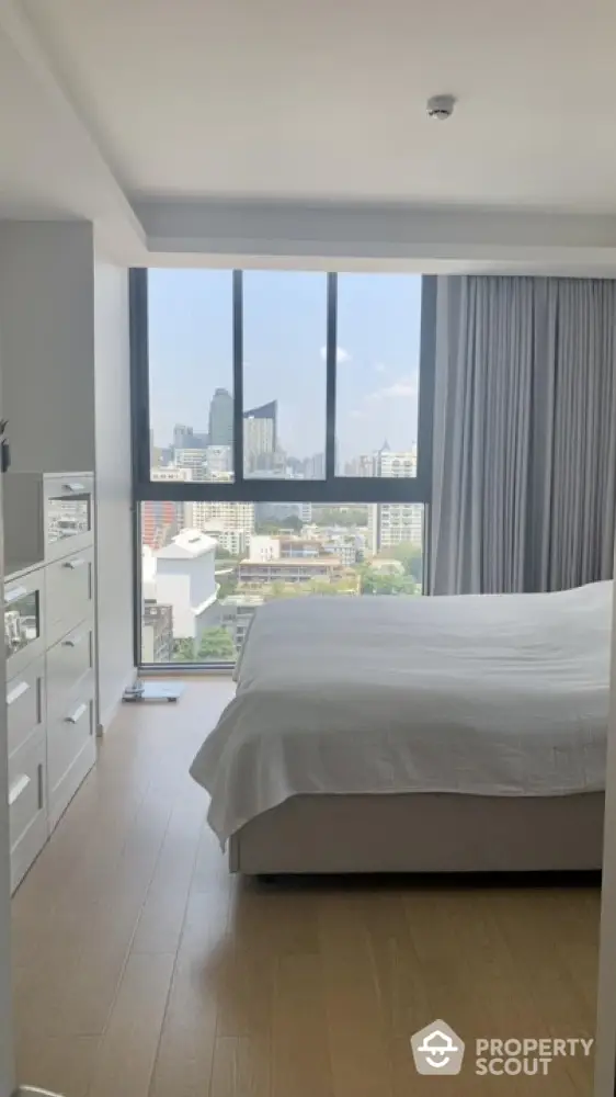 Modern bedroom with city view and natural light