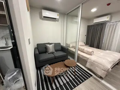 Modern studio apartment with cozy living area and bedroom, featuring air conditioning and stylish decor.