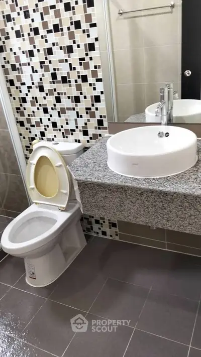 Modern bathroom with stylish mosaic tiles and sleek fixtures