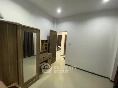 Spacious bedroom with modern wooden furniture and sleek lighting