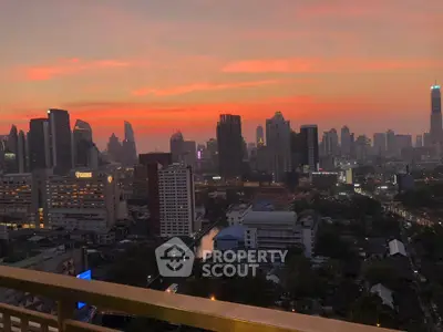 Stunning city skyline view at sunset from a high-rise balcony, perfect for urban living enthusiasts.
