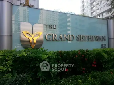 Luxurious entrance sign of The Grand Sethiwarn amidst lush greenery.