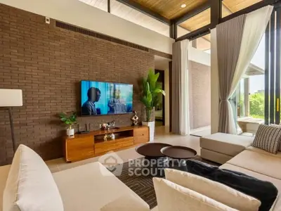 Luxurious modern living room with stylish decor and large windows offering natural light and garden view.