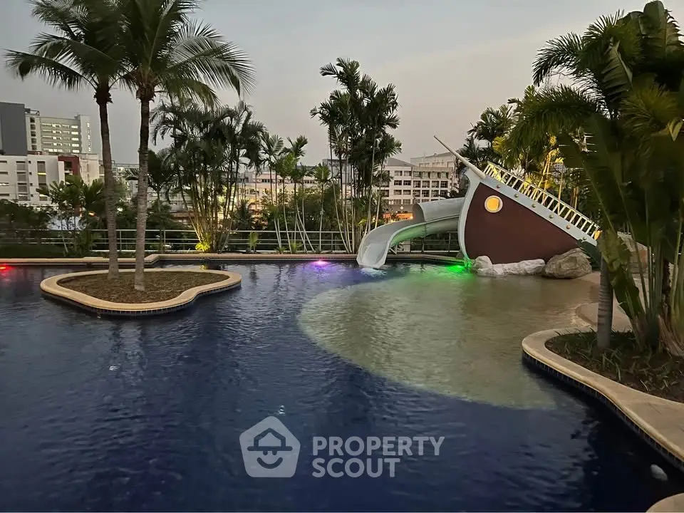 Luxurious pool area with tropical landscaping and unique ship-themed slide, perfect for family relaxation and entertainment.