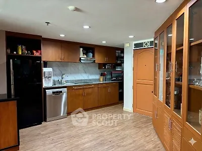 Spacious kitchen with wooden cabinets and modern appliances, perfect for culinary enthusiasts.