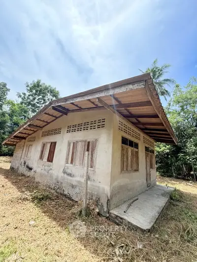 Charming rustic house with wooden shutters surrounded by lush greenery, perfect for a serene countryside retreat.