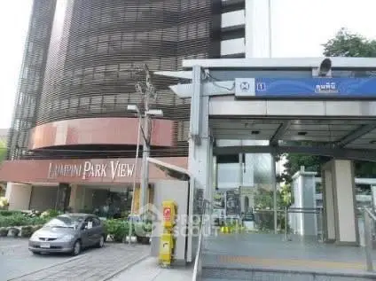 Modern building exterior near public transportation entrance, ideal for urban living.