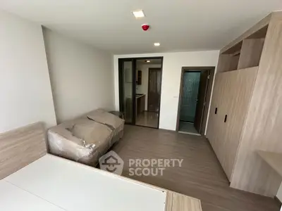 Spacious modern bedroom with wooden flooring and built-in wardrobe
