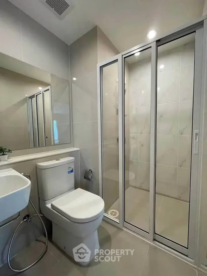 Modern bathroom with sleek shower enclosure and contemporary fixtures
