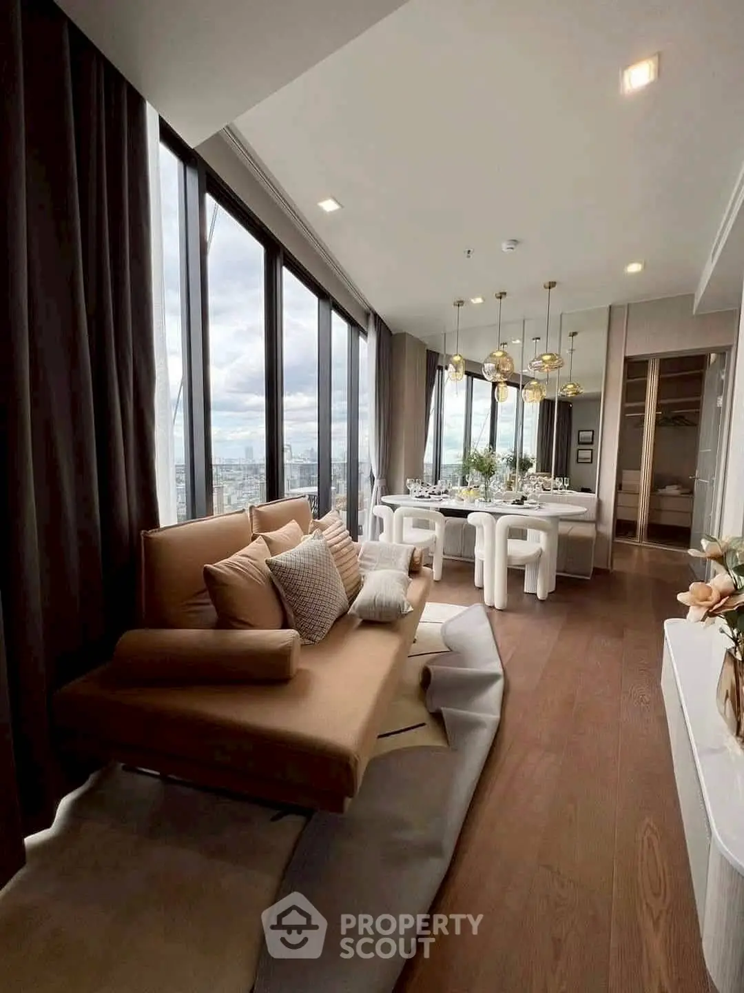 Luxurious modern living room with panoramic city views and elegant dining area.