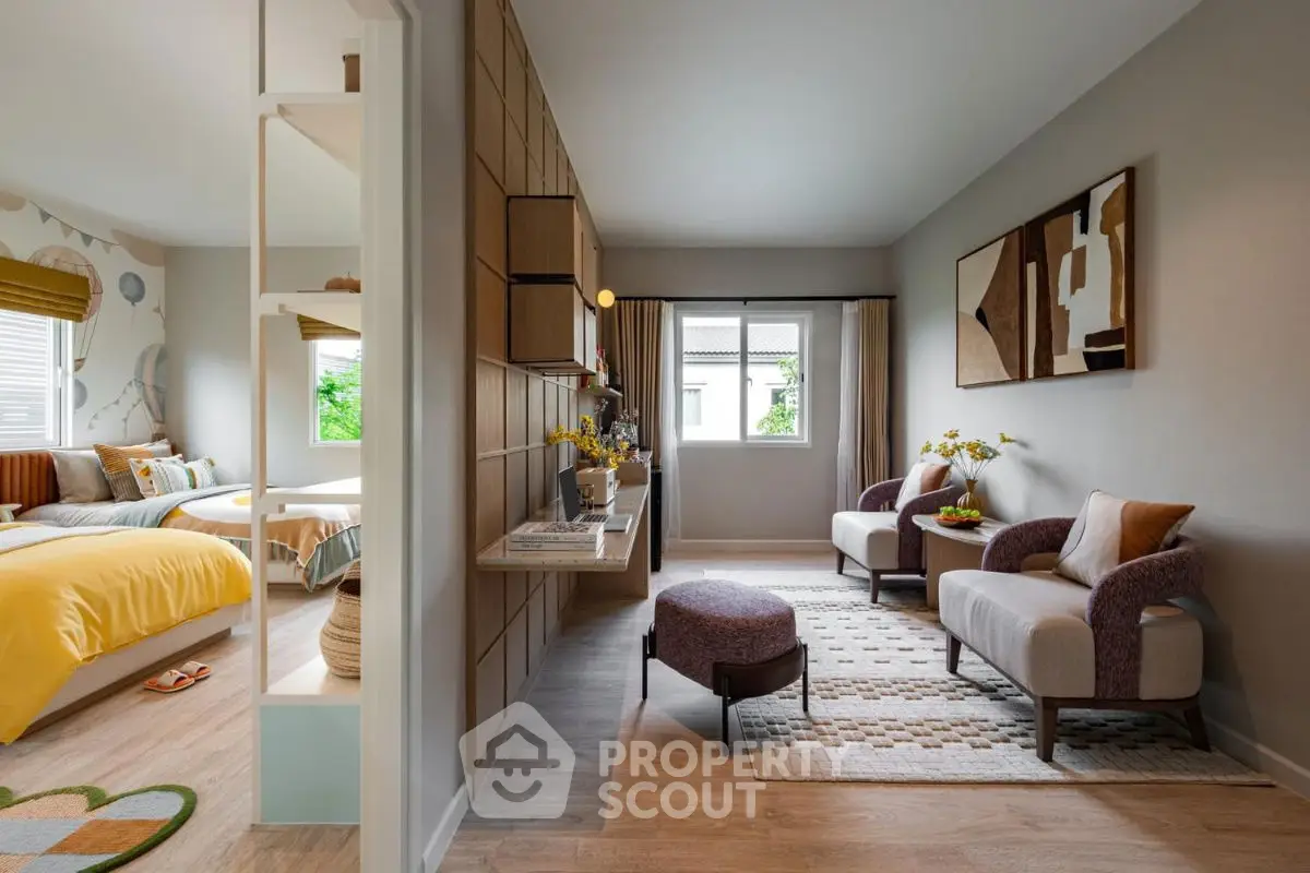 Stylish modern living room with cozy seating and natural light, adjacent to a bright bedroom.