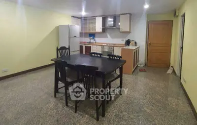 Spacious kitchen with dining area and modern appliances in open layout.