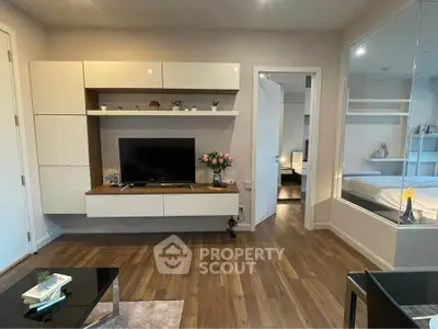 Modern living room with sleek TV unit and cozy bedroom view