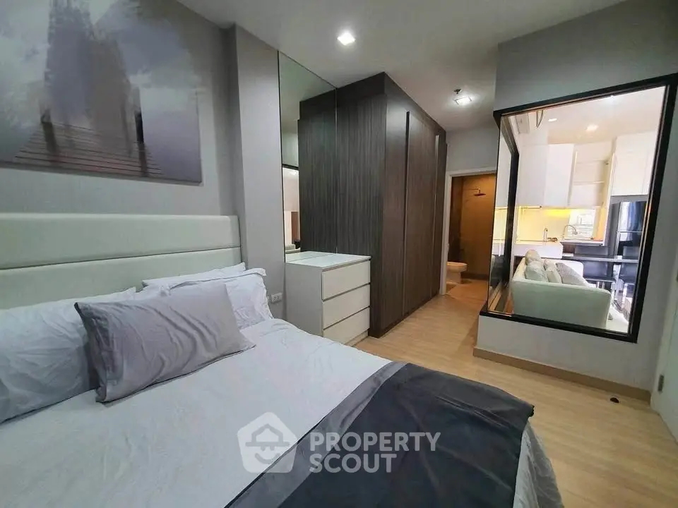 Modern bedroom with sleek design and mirrored wardrobe in stylish apartment.
