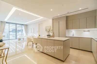 Luxurious open-plan kitchen and living area with modern design and ample natural light.