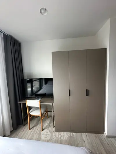 Modern bedroom with sleek wardrobe and study desk setup