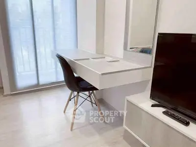Modern study area with sleek desk and TV in bright apartment