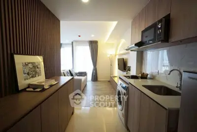 Modern open-layout kitchen with sleek appliances and cozy living area