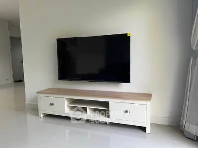 Modern living room with sleek TV unit and mounted flat-screen TV