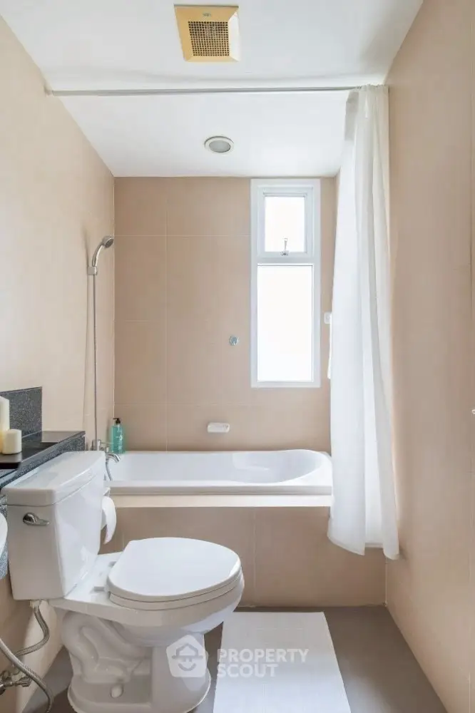 Modern bathroom with bathtub and natural light from window