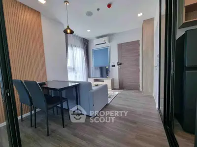 Modern living room with stylish decor and open layout, featuring sleek furniture and natural light.