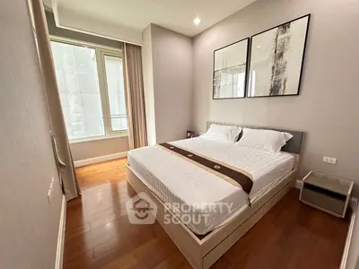 Modern bedroom with wooden flooring and large window in a stylish apartment