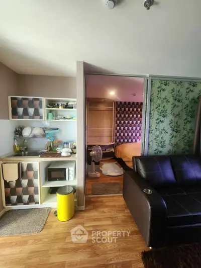Cozy studio apartment with modern kitchenette and stylish decor, perfect for urban living.