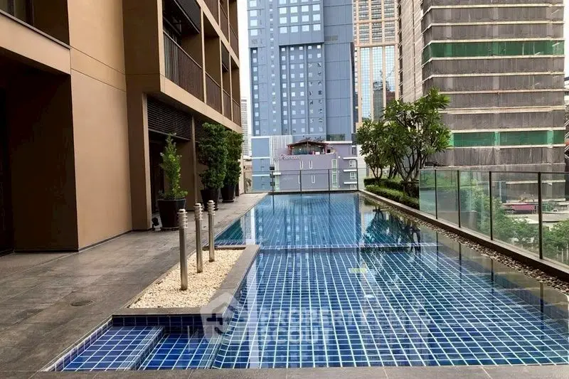 Luxurious urban swimming pool with cityscape view, perfect for relaxation and leisure in a modern residential complex.