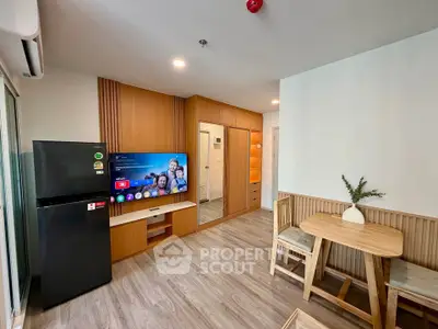 Modern living room with wooden accents, flat-screen TV, and dining area in a cozy apartment.