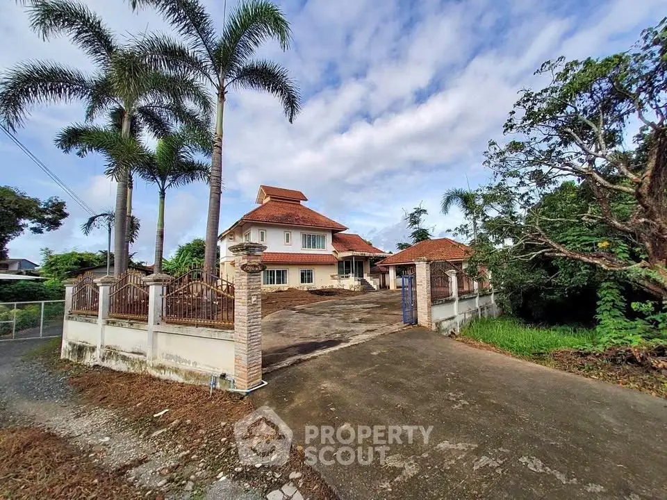Charming suburban house with spacious driveway and lush greenery, perfect for family living.