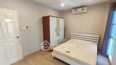 Modern bedroom with air conditioning and minimalist furniture