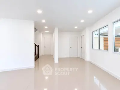 Spacious modern interior with glossy tiled floors and ample natural light, perfect for customization.