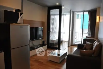Modern living room with sleek furniture and balcony access