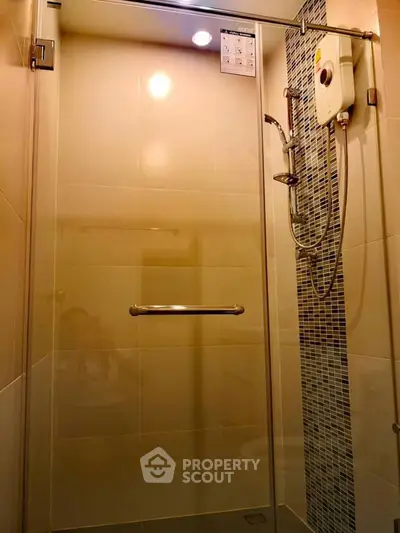 Modern bathroom shower with sleek glass door and stylish tile accents