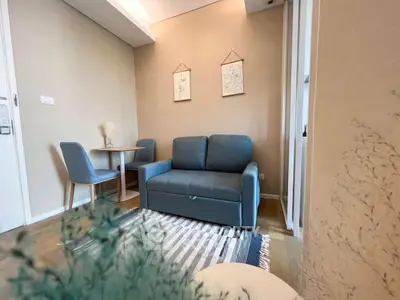 Cozy living room with modern decor and comfortable seating in a stylish apartment.