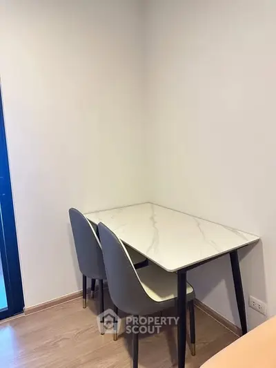 Modern minimalist dining area with marble table and sleek chairs