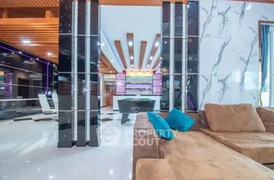 Luxurious modern living room with stylish decor and pool table, perfect for entertainment.