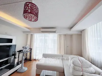 Spacious living room with modern decor and large windows for natural light.