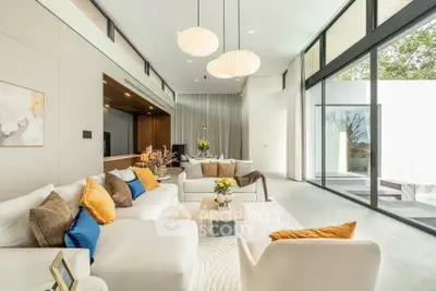 Luxurious modern living room with high ceilings and large windows