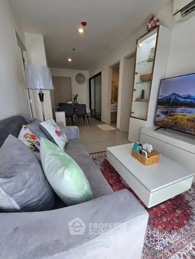 Modern living room with cozy gray sofa and stylish decor